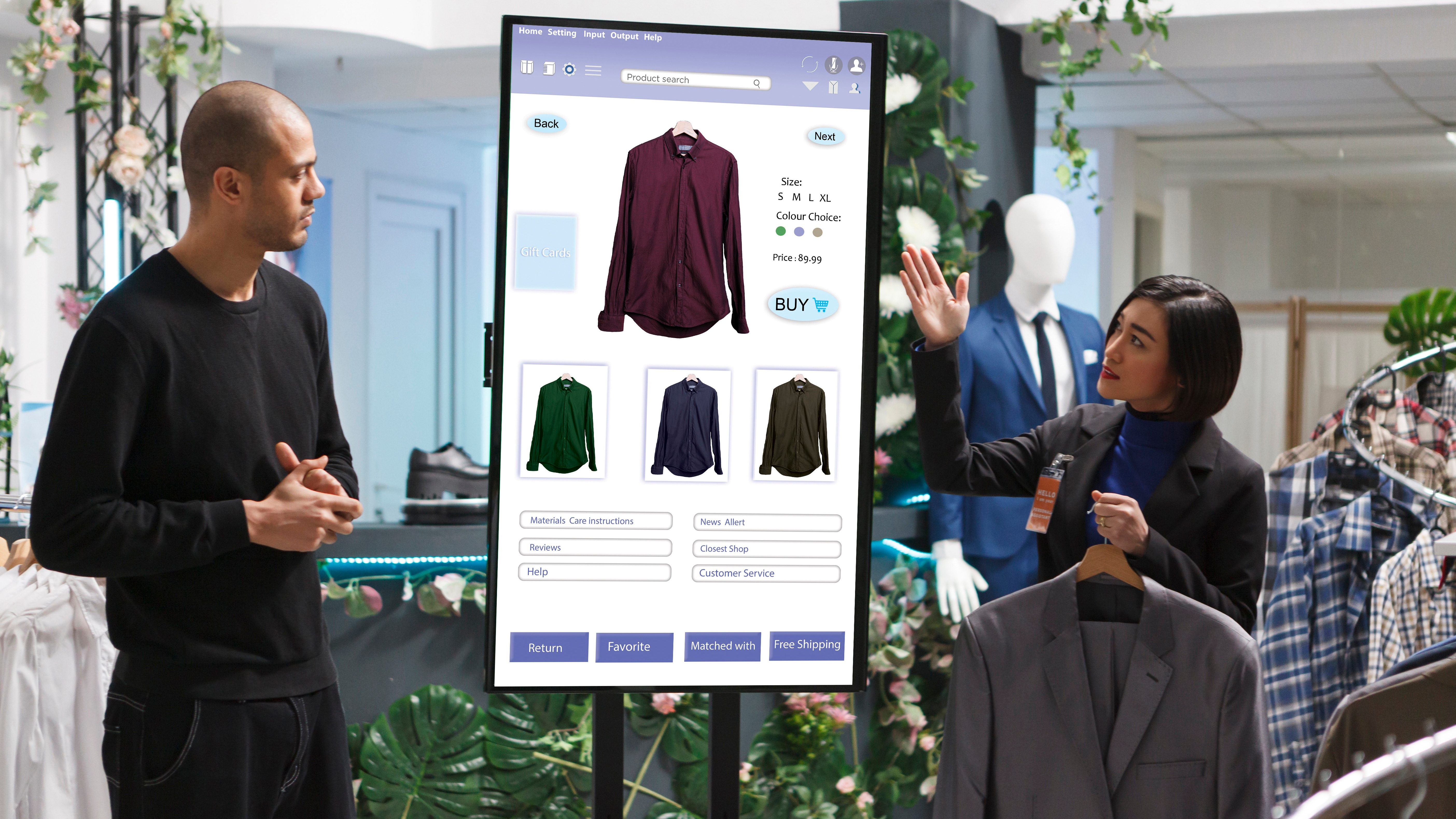 Un homme et une femme regardent des vêtements exposés sur un grand présentoir.