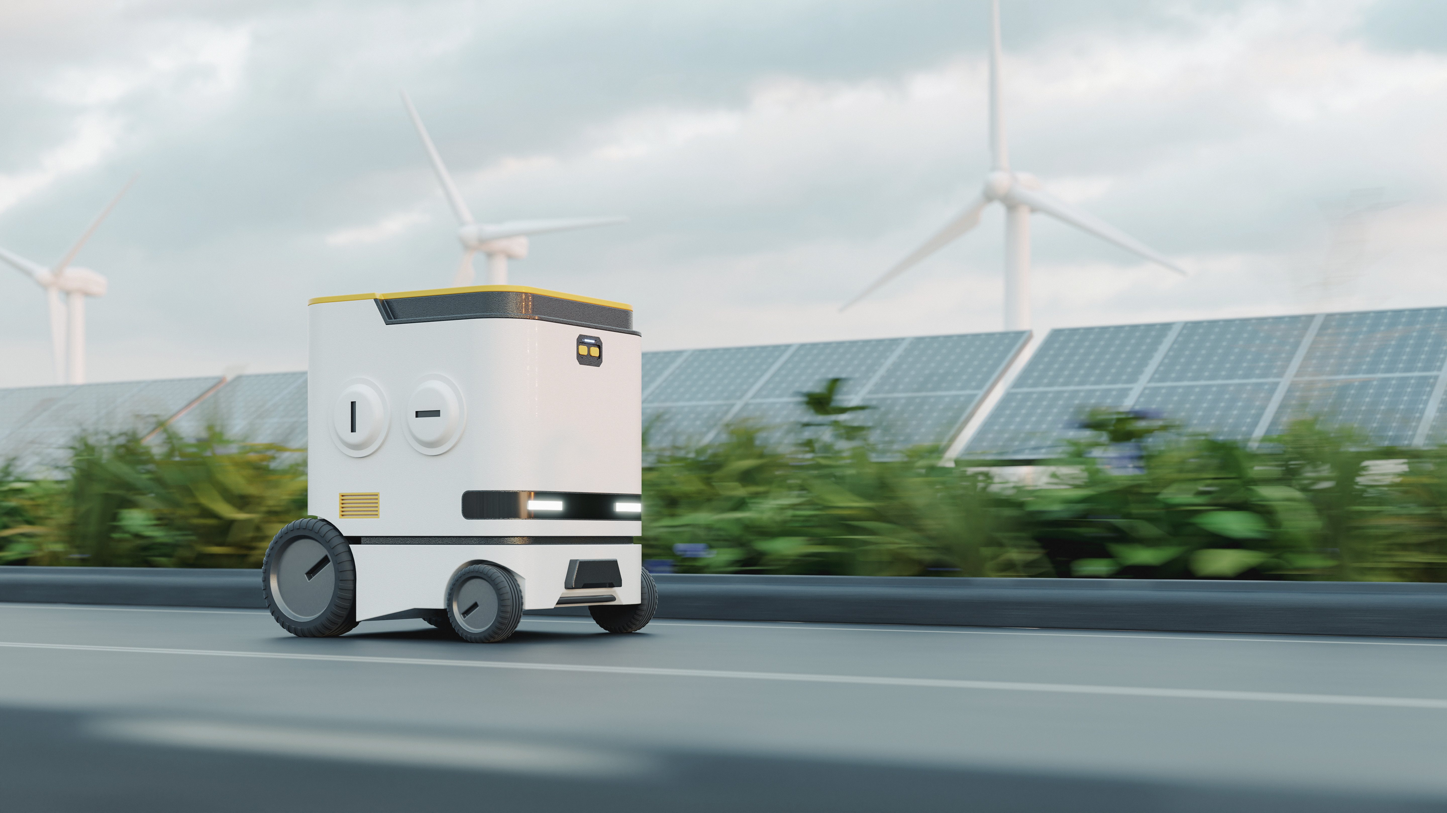 A modern autonomous delivery robot is driving down a paved road—with solar panels and white wind turbines in the background. The robot is white with yellow accents and a simple design.